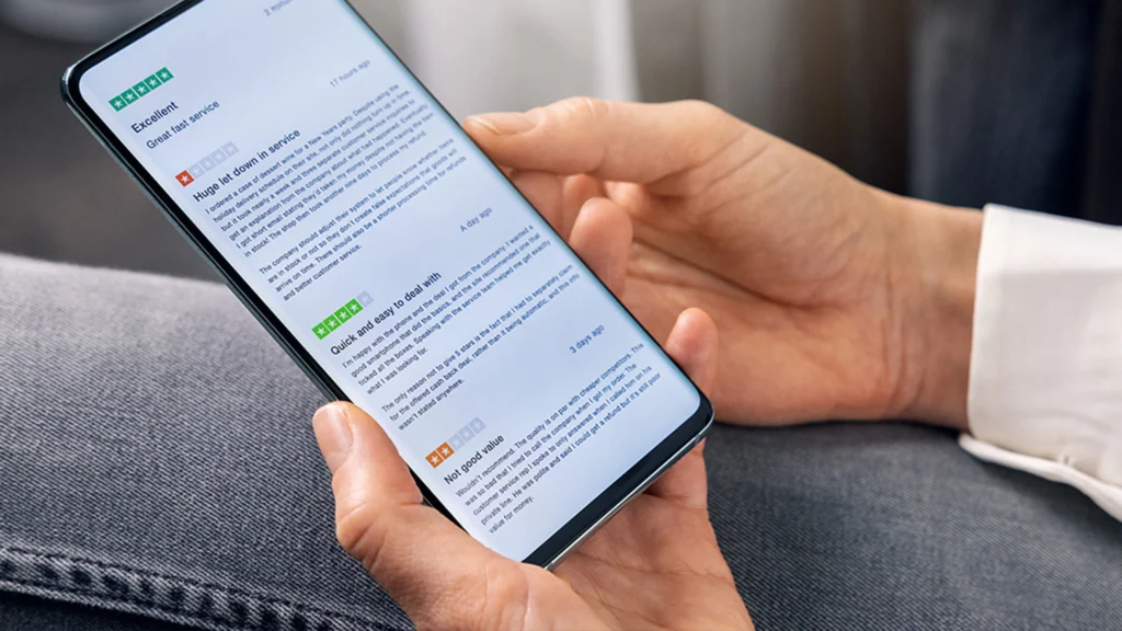 Man checking his phone and reading negative review about his practice