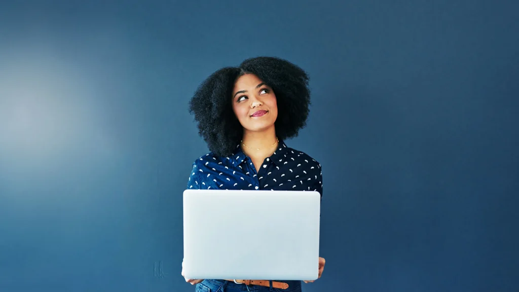 Woman in front of her laptop considering leaving an online review for her doctor and medspa
