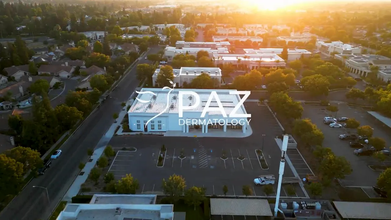 From the practice’s homepage film: a sunset flyover of the Paz Dermatology building.