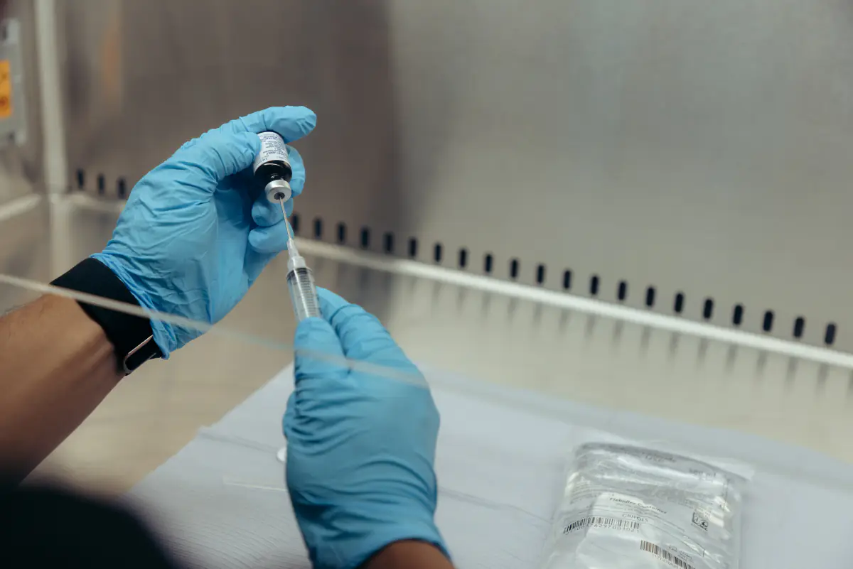 Drawing medication from a vial under the lab hood.