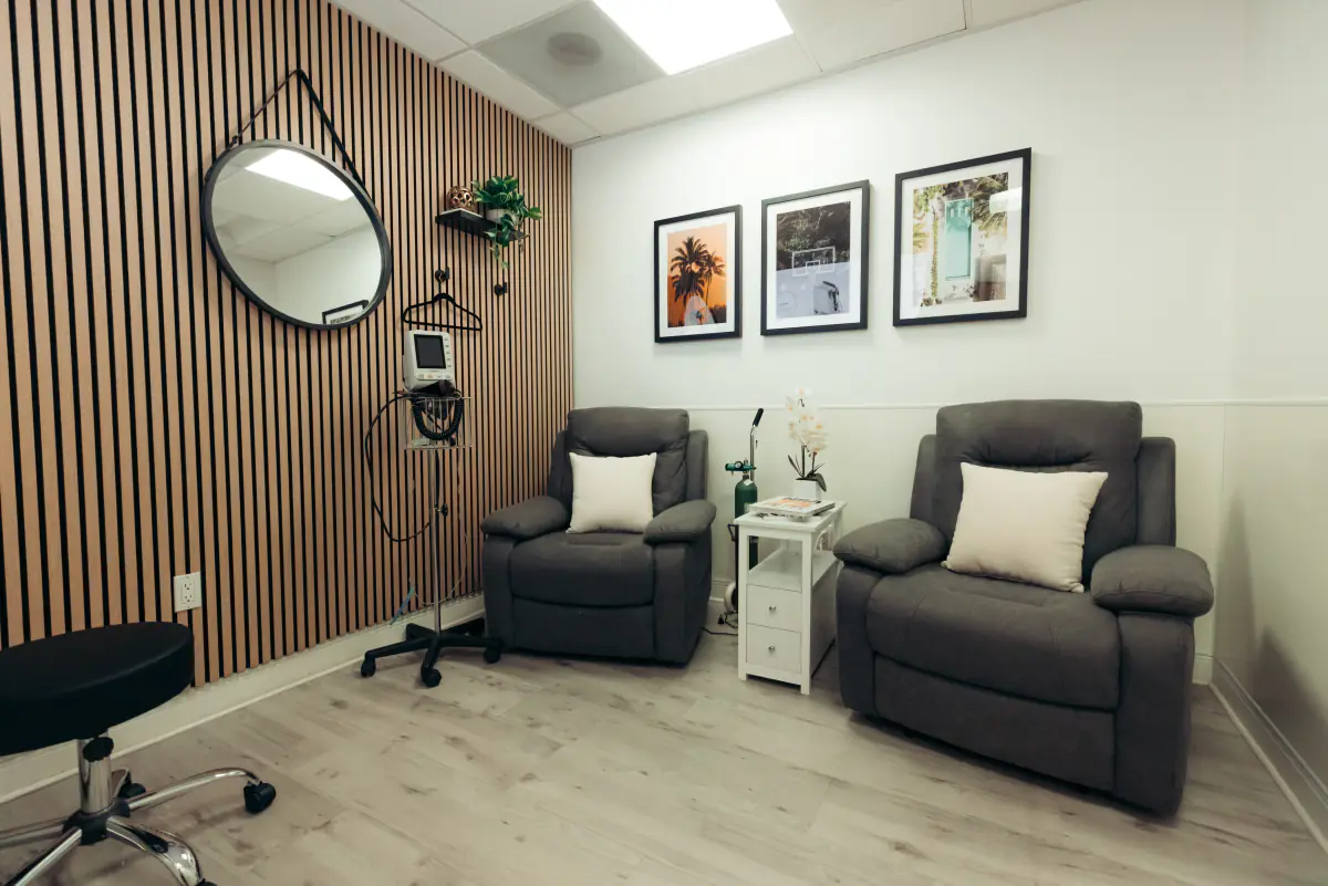 The infusion suite: two recliners against a slatted walnut wall.