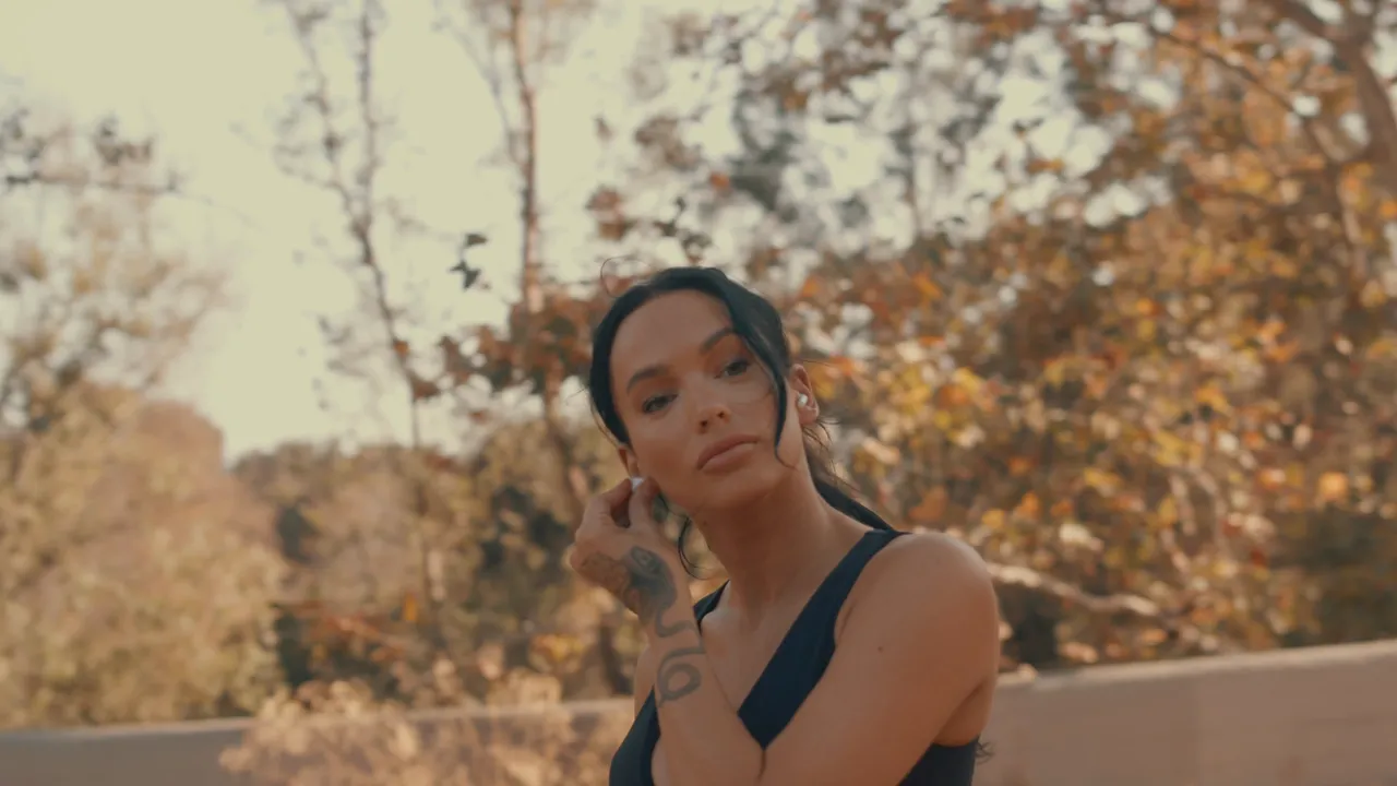 From the Reveal Lasers homepage film: a woman in late-afternoon light among autumn trees.
