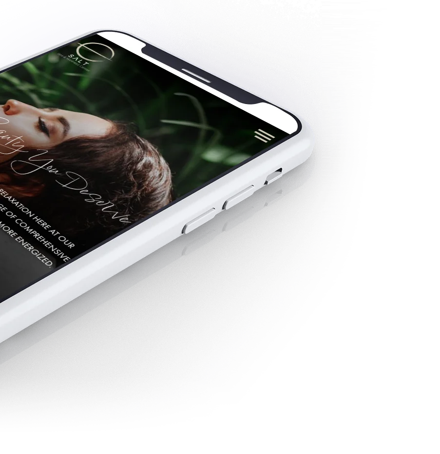 The Salt Spa homepage on a phone, tilted.